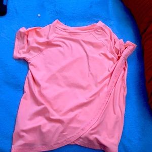 a peach colored athleta shirt